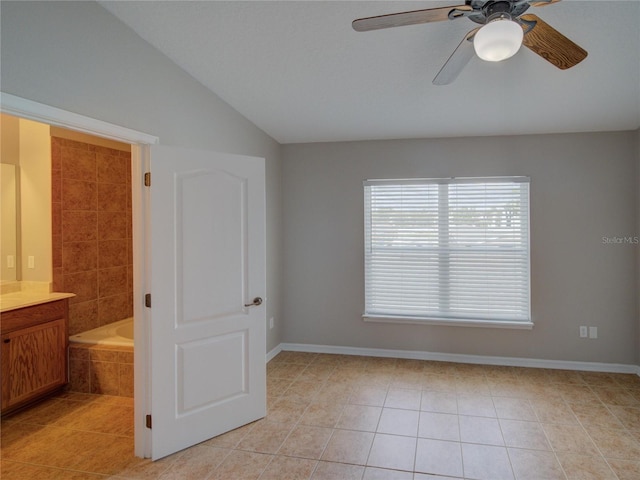 7462 Bentonshire Ave, Windermere, FL 34786 - unfurnished bedroom with light tile patterned floors, vaulted ceiling, connected bathroom, and ceiling fan