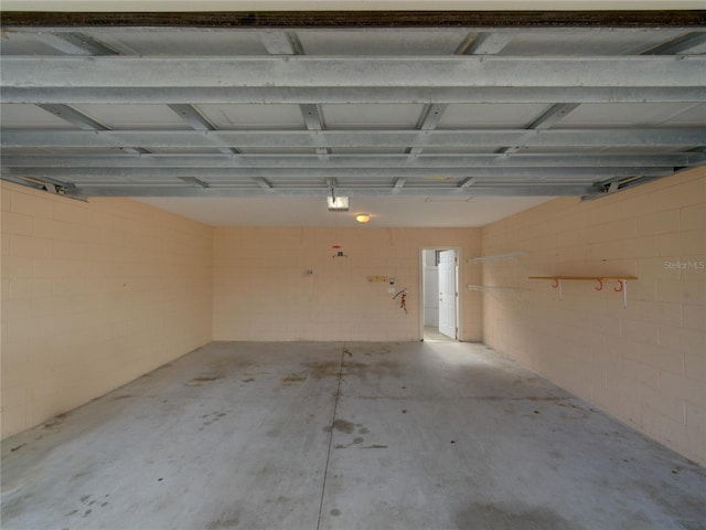 7462 Bentonshire Ave, Windermere, FL 34786 - garage featuring a garage door opener and concrete block wall