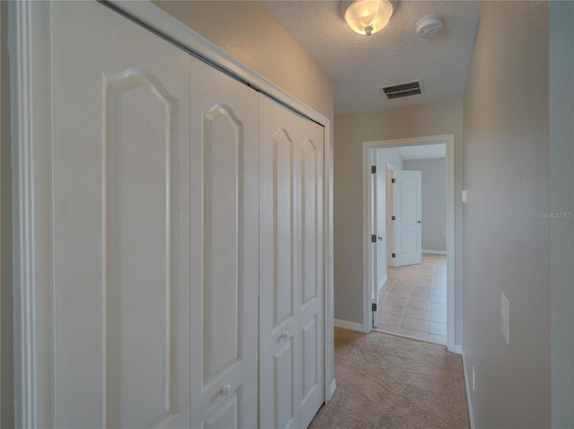 7462 Bentonshire Ave, Windermere, FL 34786 - hallway featuring a textured ceiling and light colored carpet