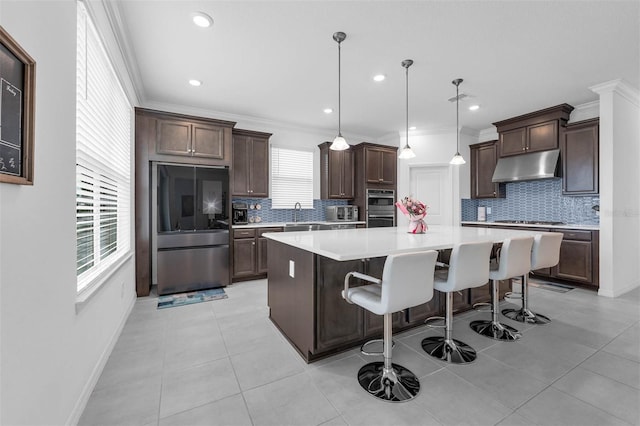 1593 Osprey View Dr, Apopka, FL 32703 - kitchen with stainless steel appliances, under cabinet range hood, a center island, tasteful backsplash, and recessed lighting