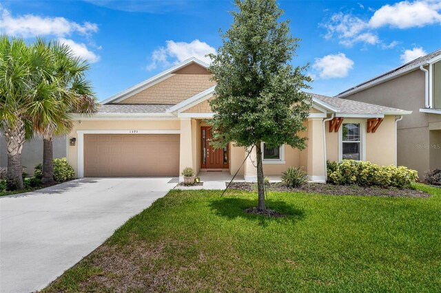 1593 Osprey View Dr, Apopka, FL 32703 - view of front facade with an attached garage, concrete driveway, stucco siding, and a front lawn