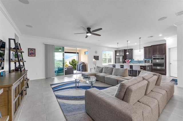 1593 Osprey View Dr, Apopka, FL 32703 - living area with ceiling fan, light tile patterned flooring, ornamental molding, recessed lighting, and a textured ceiling