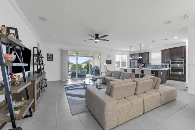 1593 Osprey View Dr, Apopka, FL 32703 - living room with ceiling fan, light tile patterned flooring, and crown molding
