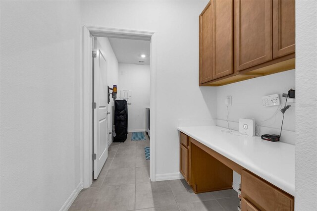1593 Osprey View Dr, Apopka, FL 32703 - kitchen featuring brown cabinets, built in study area, light tile patterned floors, light countertops, and recessed lighting