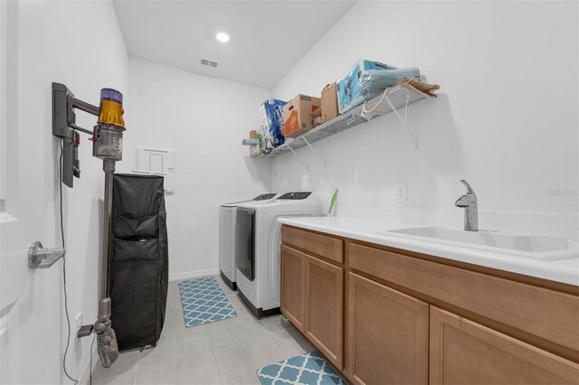 1593 Osprey View Dr, Apopka, FL 32703 - washroom with independent washer and dryer, light tile patterned flooring, and cabinet space