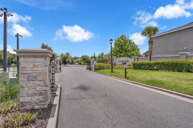 1593 Osprey View Dr, Apopka, FL 32703 - view of asphalt road featuring street lights, a gate, a gated entry, and curbs