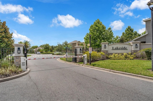 1593 Osprey View Dr, Apopka, FL 32703 - view of asphalt road featuring curbs, a gated entry, and a gate