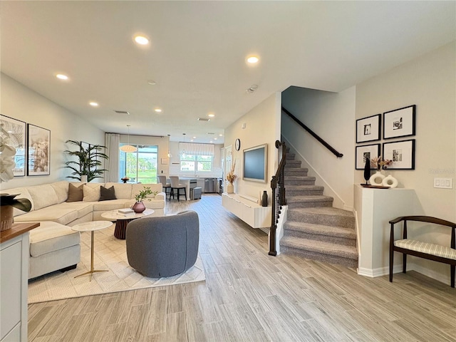 4171 Via Sienna Cir, Sarasota, FL 34243 - living room featuring light wood-style flooring, stairs, and recessed lighting