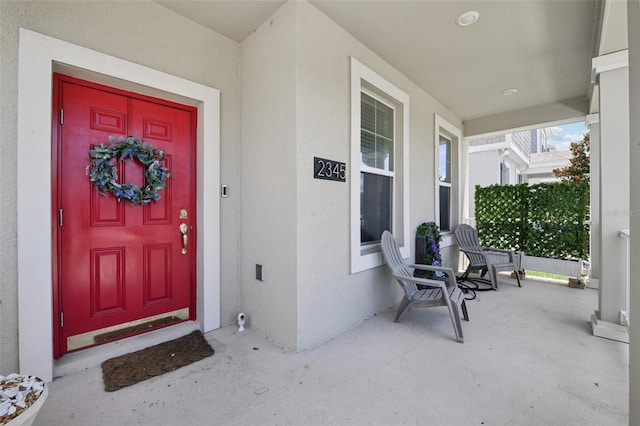 2345 Volunteer Ave, Kissimmee, FL 34744 - view of exterior entry with covered porch and stucco siding