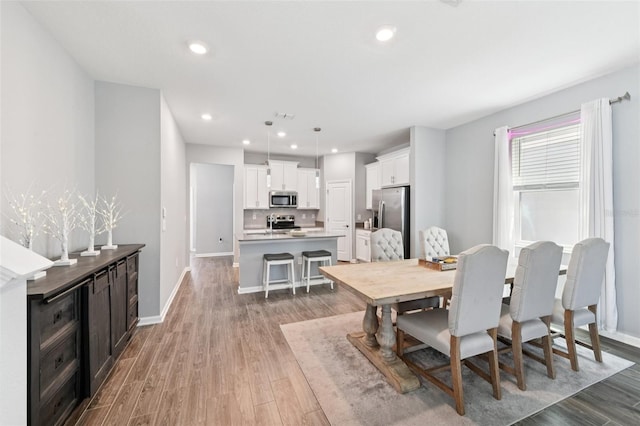 2345 Volunteer Ave, Kissimmee, FL 34744 - dining area with light wood-style flooring and recessed lighting