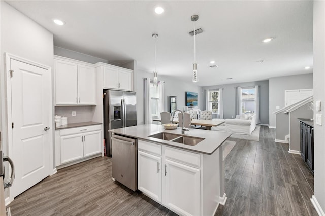 2345 Volunteer Ave, Kissimmee, FL 34744 - kitchen featuring appliances with stainless steel finishes, open floor plan, white cabinetry, a kitchen island with sink, and recessed lighting