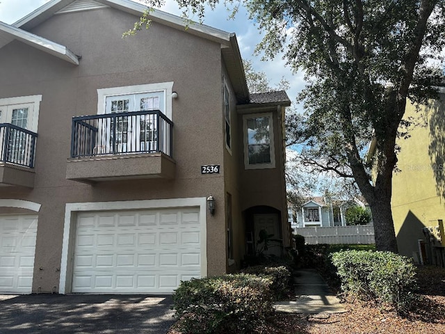 2536 Lancien Ct Unit 5, Orlando, FL 32826 - view of front of home featuring a balcony, stucco siding, and an attached garage