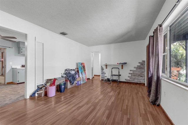 905 Flewelling Ave, Ocoee, FL 34761 - bonus room featuring stairway, wood finished floors, a textured ceiling, and a ceiling fan