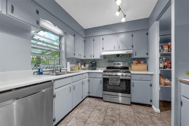 905 Flewelling Ave, Ocoee, FL 34761 - kitchen with appliances with stainless steel finishes, under cabinet range hood, light countertops, and light tile patterned floors