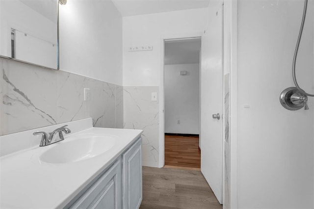 905 Flewelling Ave, Ocoee, FL 34761 - bathroom with tile walls, vanity, wood finished floors, and a wainscoted wall