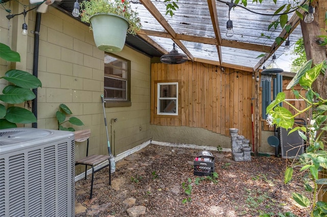 905 Flewelling Ave, Ocoee, FL 34761 - view of home's exterior featuring a central air condition unit and a pergola