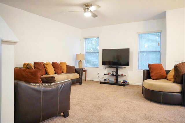 3569 Seneca Club Loop Unit 13, Orlando, FL 32808 - living room with ceiling fan and light colored carpet