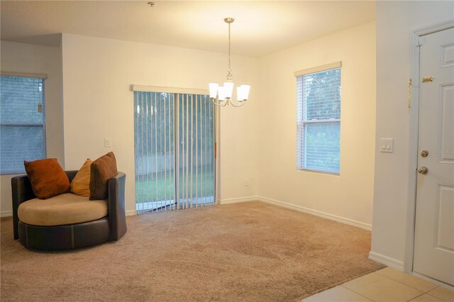 3569 Seneca Club Loop Unit 13, Orlando, FL 32808 - sitting room with a chandelier and carpet floors