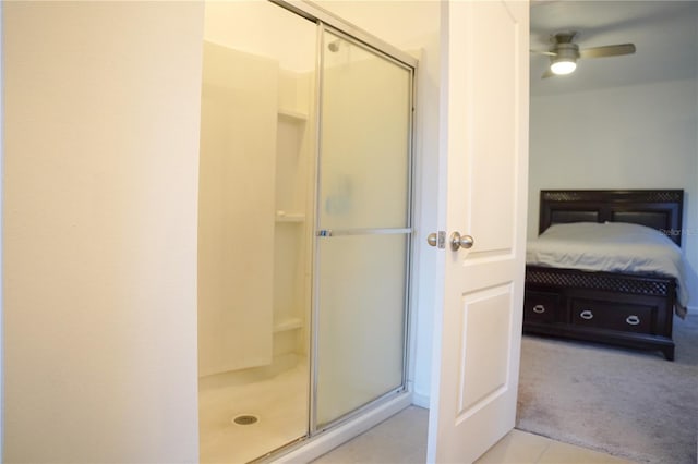 3569 Seneca Club Loop Unit 13, Orlando, FL 32808 - ensuite bathroom with a stall shower, a ceiling fan, and tile patterned floors