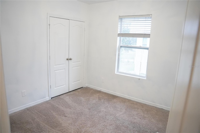 3569 Seneca Club Loop Unit 13, Orlando, FL 32808 - unfurnished bedroom with carpet floors and a closet