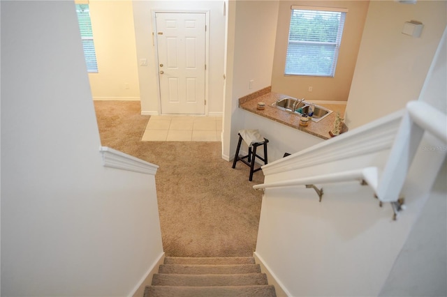 3569 Seneca Club Loop Unit 13, Orlando, FL 32808 - stairway featuring carpet floors and baseboards
