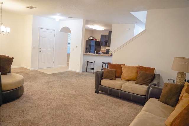 3569 Seneca Club Loop Unit 13, Orlando, FL 32808 - living area with light colored carpet, a chandelier, and arched walkways