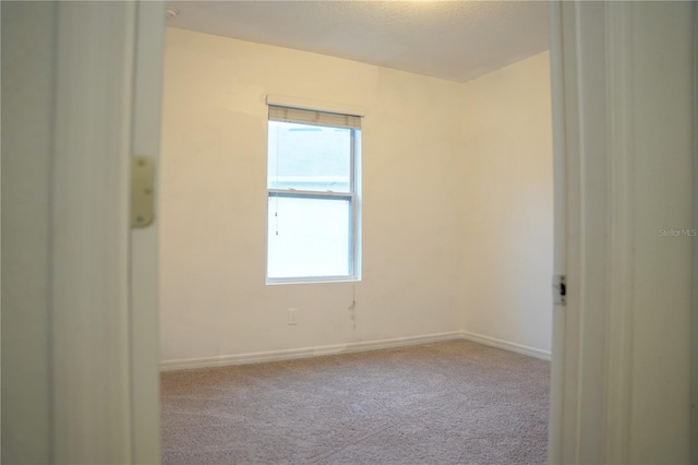 3569 Seneca Club Loop Unit 13, Orlando, FL 32808 - carpeted spare room with baseboards