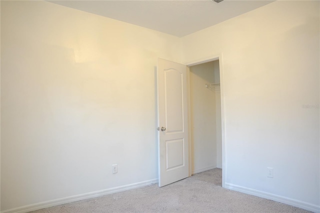 3569 Seneca Club Loop Unit 13, Orlando, FL 32808 - unfurnished bedroom featuring light colored carpet and baseboards