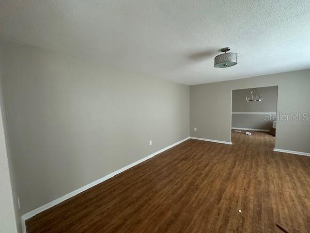 4732 Luce Rd, Lakeland, FL 33813 - empty room featuring dark wood finished floors and a textured ceiling