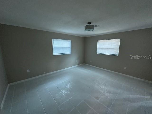 4732 Luce Rd, Lakeland, FL 33813 - unfurnished room with baseboards and tile patterned floors