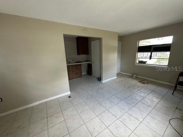 4732 Luce Rd, Lakeland, FL 33813 - spare room featuring baseboards and light tile patterned floors