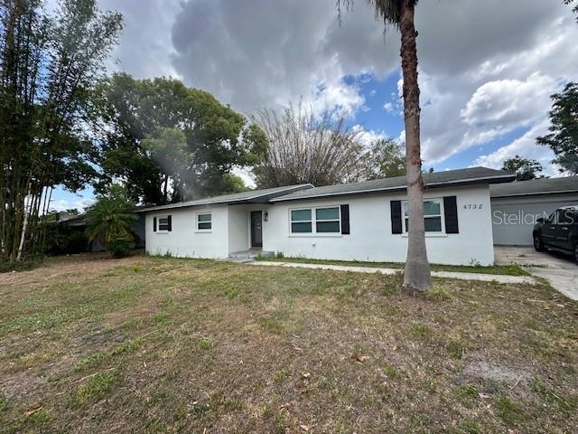 4732 Luce Rd, Lakeland, FL 33813 - ranch-style house with stucco siding and a front lawn
