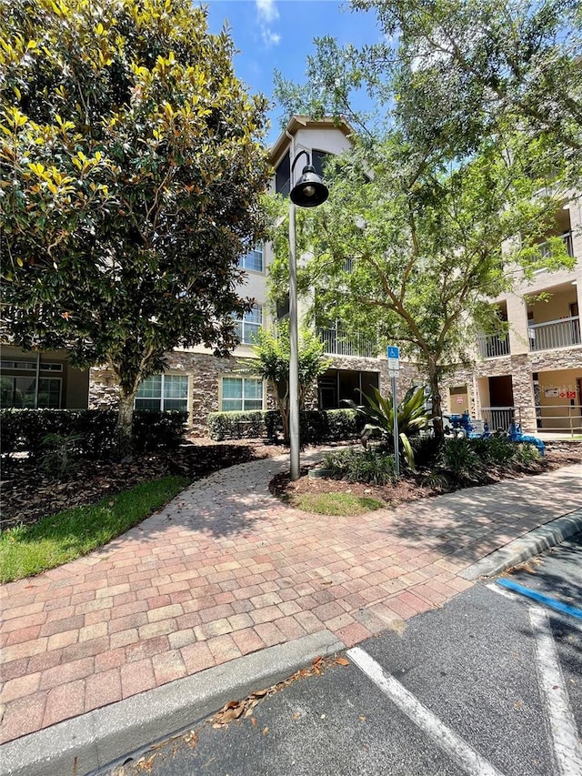 8010 Tuscany Way Unit 3102, Davenport, FL 33896 - view of front of home featuring stone siding and uncovered parking