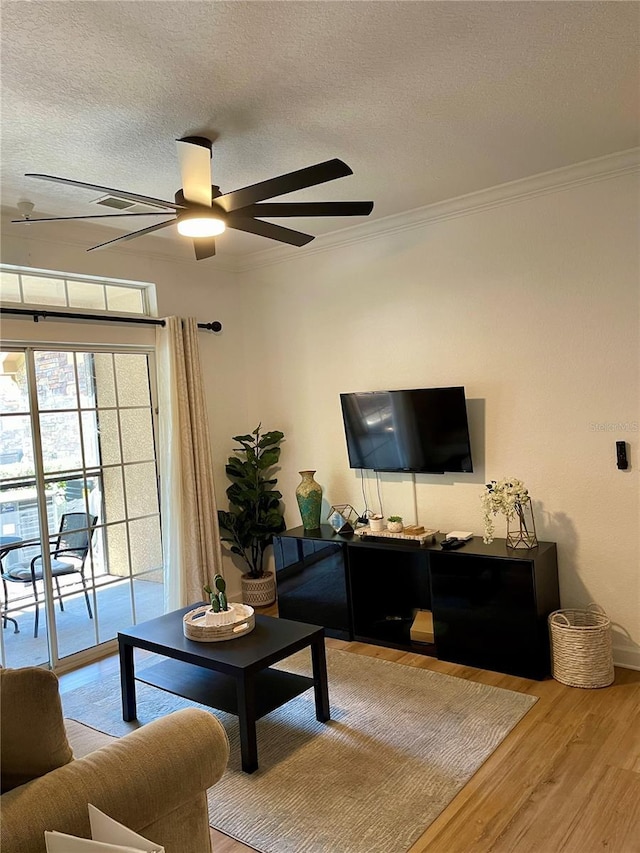 8010 Tuscany Way Unit 3102, Davenport, FL 33896 - living area with wood finished floors, a textured ceiling, ornamental molding, and ceiling fan