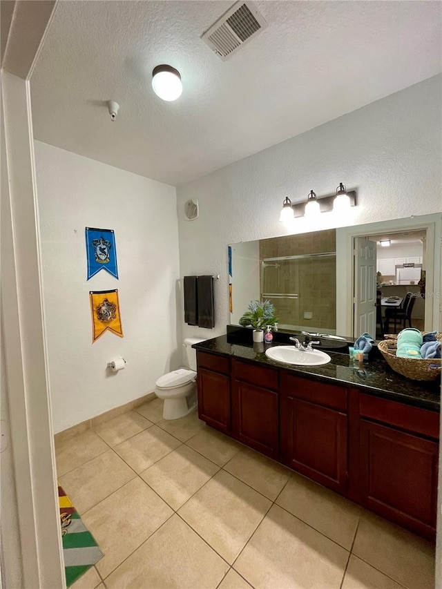 8010 Tuscany Way Unit 3102, Davenport, FL 33896 - bathroom with a shower stall, tile patterned floors, vanity, and a textured ceiling
