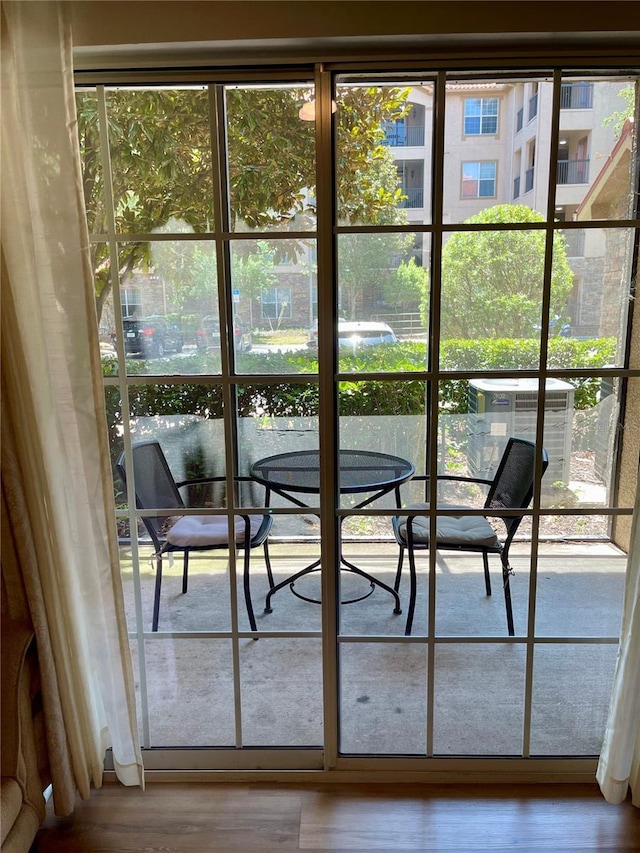 8010 Tuscany Way Unit 3102, Davenport, FL 33896 - doorway to outside featuring healthy amount of natural light and wood finished floors