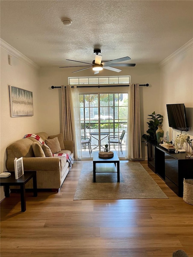8010 Tuscany Way Unit 3102, Davenport, FL 33896 - living area featuring a ceiling fan, ornamental molding, wood finished floors, and a textured ceiling