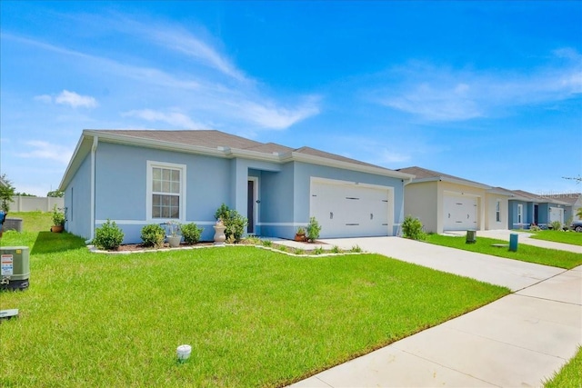 145 Piave St, Haines City, FL 33844 - view of front of home with a garage, concrete driveway, a front lawn, and stucco siding