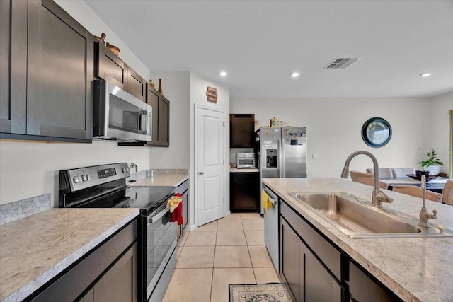 145 Piave St, Haines City, FL 33844 - kitchen featuring appliances with stainless steel finishes, light countertops, recessed lighting, and light tile patterned floors