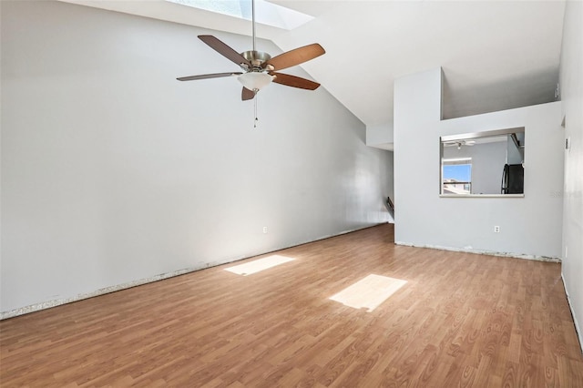 3118 S Semoran Blvd Unit 2, Orlando, FL 32822 - unfurnished living room with wood finished floors, a ceiling fan, a skylight, and high vaulted ceiling