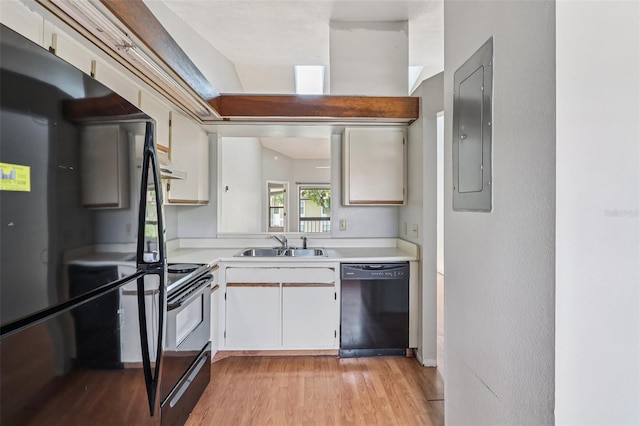 3118 S Semoran Blvd Unit 2, Orlando, FL 32822 - kitchen featuring black appliances, light countertops, light wood-style flooring, electric panel, and under cabinet range hood