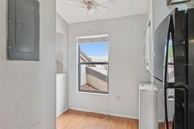 3118 S Semoran Blvd Unit 2, Orlando, FL 32822 - laundry area with electric panel, stacked washer and clothes dryer, light wood finished floors, and ceiling fan