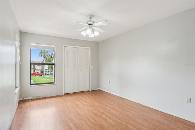 3118 S Semoran Blvd Unit 2, Orlando, FL 32822 - unfurnished bedroom with light wood finished floors, ceiling fan, and a closet