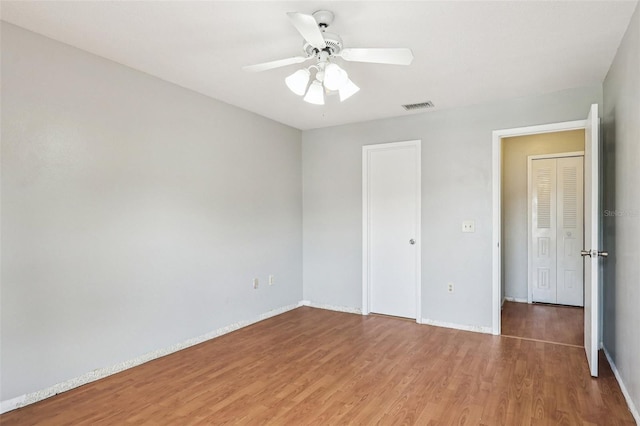 3118 S Semoran Blvd Unit 2, Orlando, FL 32822 - unfurnished bedroom with wood finished floors, ceiling fan, and a closet