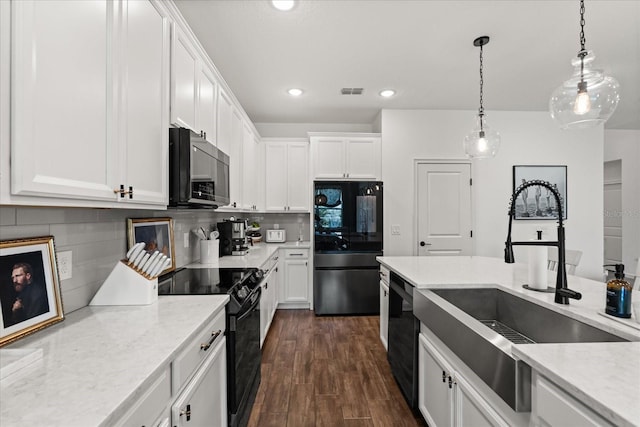 922 Grazie Loop, Davenport, FL 33837 - kitchen with black appliances, white cabinetry, hanging light fixtures, and recessed lighting