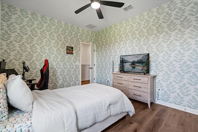 922 Grazie Loop, Davenport, FL 33837 - bedroom featuring wallpapered walls, wood finished floors, and a ceiling fan