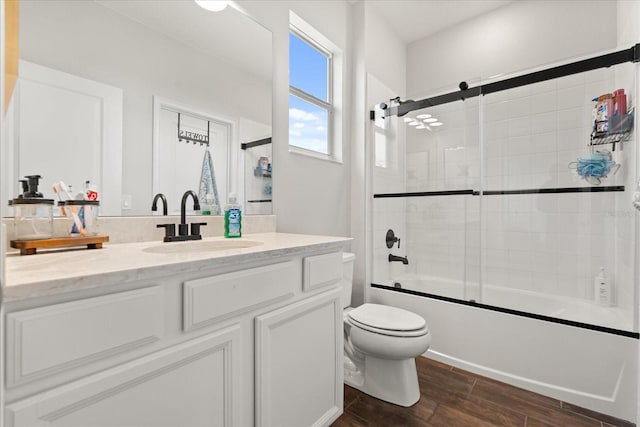 922 Grazie Loop, Davenport, FL 33837 - bathroom featuring vanity, wood finished floors, and shower / bath combination with glass door