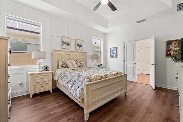 922 Grazie Loop, Davenport, FL 33837 - bedroom featuring a raised ceiling, wood finished floors, and ceiling fan