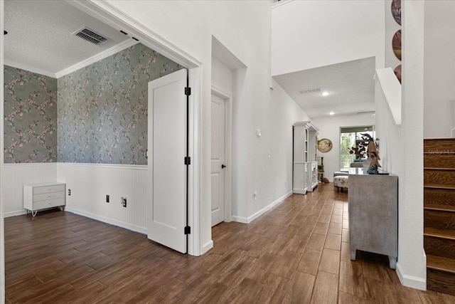 922 Grazie Loop, Davenport, FL 33837 - foyer entrance featuring wainscoting, stairs, wallpapered walls, wood finished floors, and crown molding