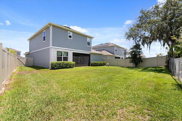 922 Grazie Loop, Davenport, FL 33837 - rear view of house with a fenced backyard and a sunroom
